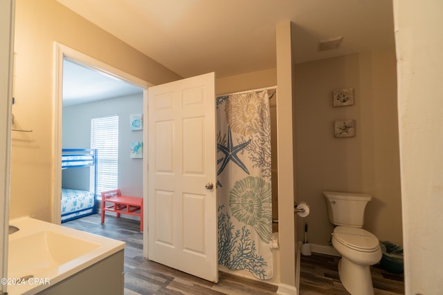 bathroom with wood-type flooring, toilet, a shower with shower curtain, and vanity