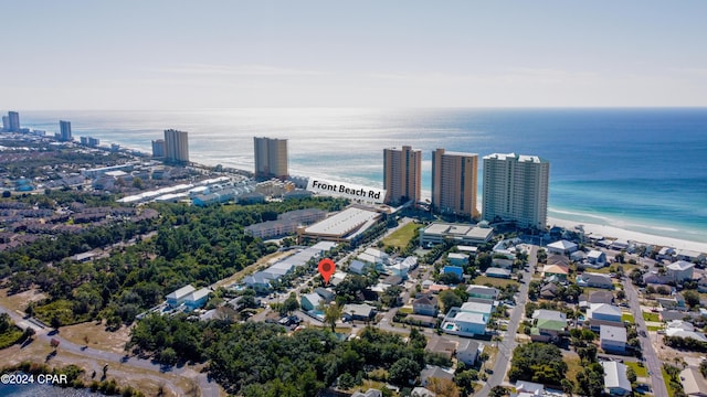 birds eye view of property with a water view and a beach view