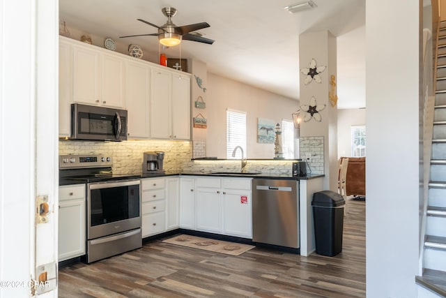 kitchen featuring white cabinetry, appliances with stainless steel finishes, dark hardwood / wood-style flooring, and sink