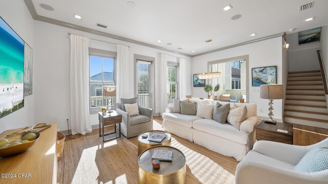 living room featuring light wood-type flooring and ornamental molding