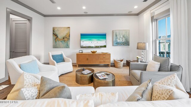 living room featuring hardwood / wood-style floors and ornamental molding