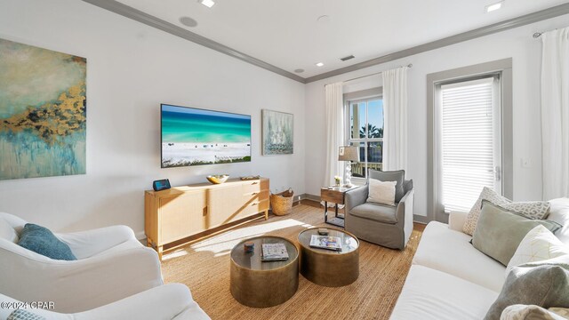 living room with ornamental molding and hardwood / wood-style flooring