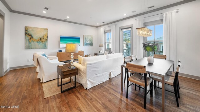 living room featuring crown molding and hardwood / wood-style flooring