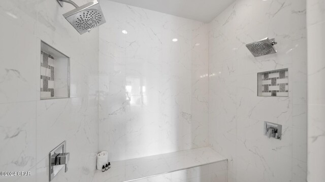 bathroom featuring tiled shower