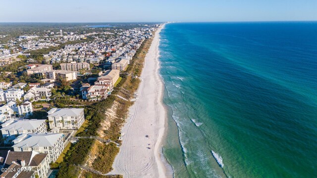 bird's eye view featuring a water view and a beach view