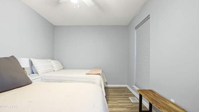 bedroom with ceiling fan and light hardwood / wood-style floors