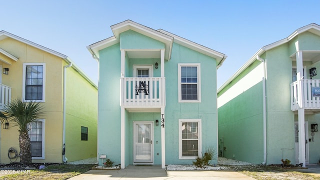 view of front of house featuring a balcony