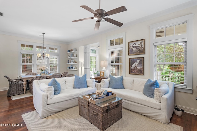 living room with wood-type flooring, ceiling fan with notable chandelier, and a healthy amount of sunlight