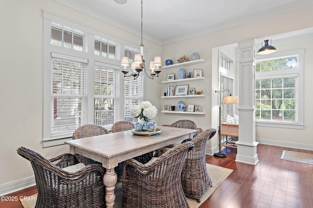 dining room with ornamental molding, decorative columns, an inviting chandelier, and dark wood-type flooring