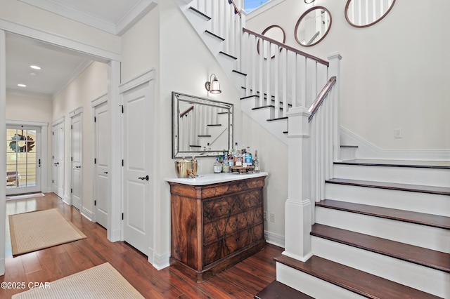 stairs featuring crown molding and wood-type flooring