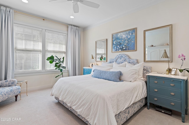 carpeted bedroom with ceiling fan and crown molding