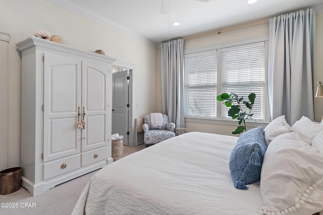 bedroom with carpet flooring, ceiling fan, and ornamental molding