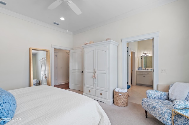 bedroom featuring ensuite bath, ceiling fan, and crown molding