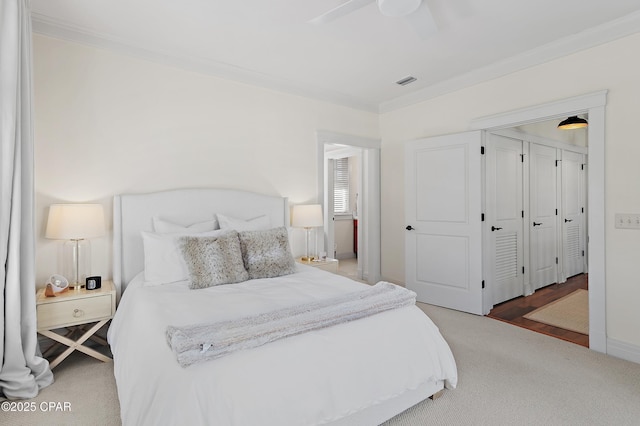 bedroom featuring hardwood / wood-style flooring, ceiling fan, and ornamental molding