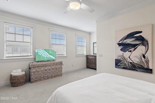 carpeted bedroom featuring ceiling fan and ornamental molding