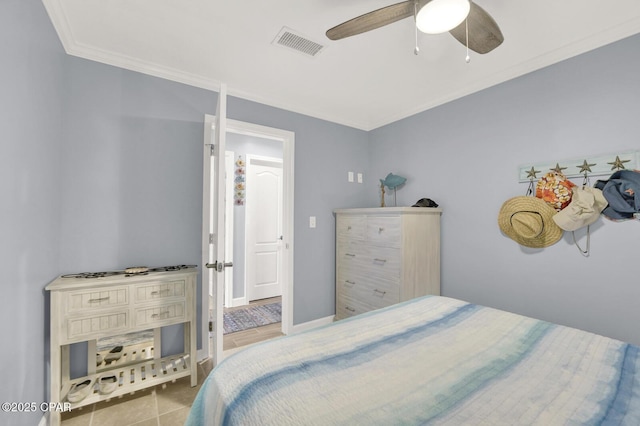 tiled bedroom featuring ornamental molding, ceiling fan, and visible vents
