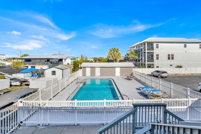 community pool with fence private yard and a patio area