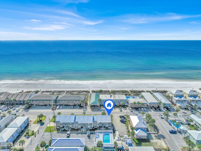 bird's eye view featuring a water view and a beach view