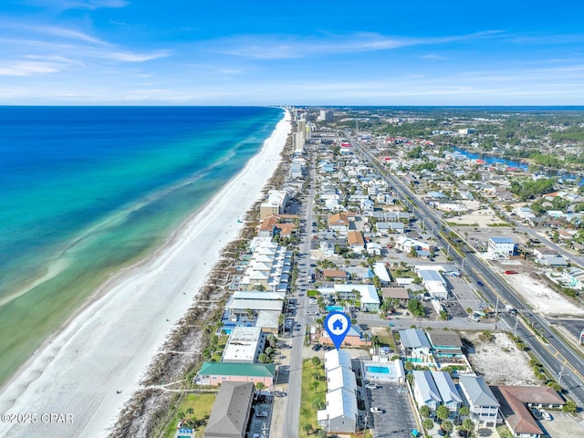 drone / aerial view featuring a beach view and a water view