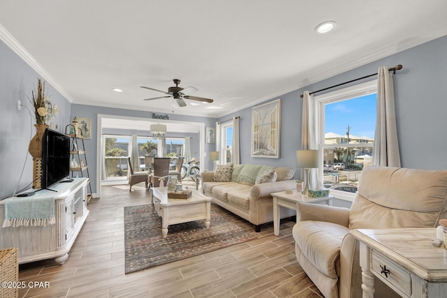 living area with crown molding, recessed lighting, light wood-style flooring, and ceiling fan