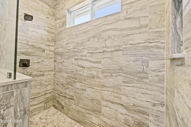 bathroom with a tile shower