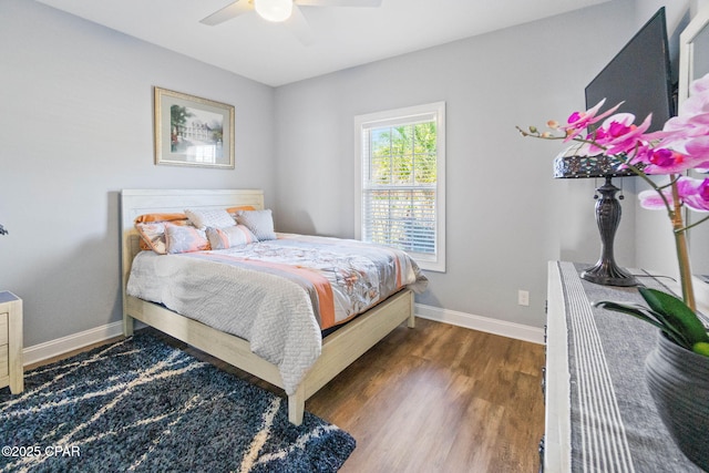 bedroom with ceiling fan and dark wood-type flooring