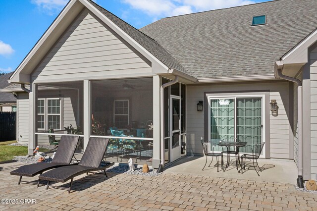 rear view of property with a patio area and a sunroom