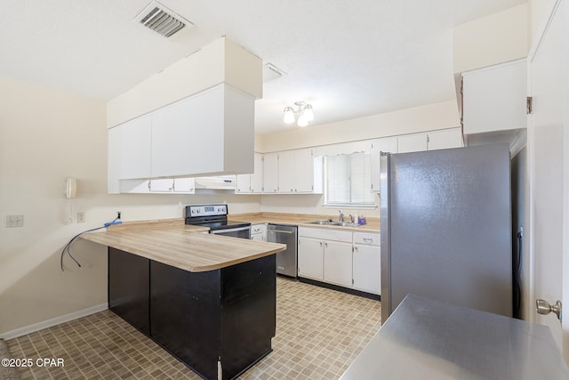 kitchen featuring sink, white cabinets, stainless steel appliances, and range hood