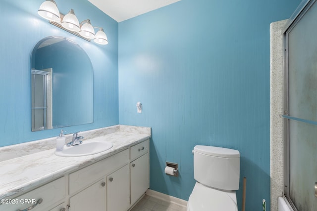 bathroom featuring an enclosed shower, vanity, toilet, and tile patterned flooring