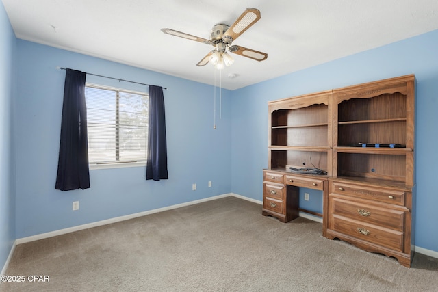 unfurnished office featuring ceiling fan and carpet floors