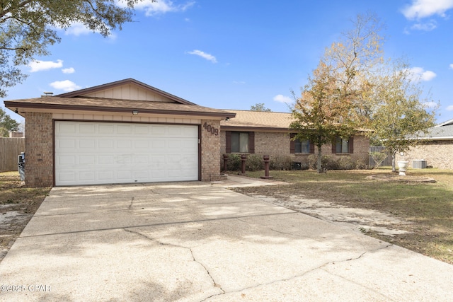 ranch-style home featuring a garage and central AC unit