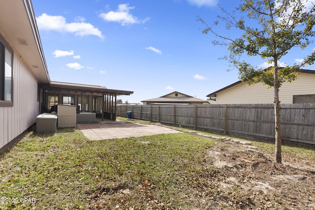 view of yard featuring a sunroom and a patio