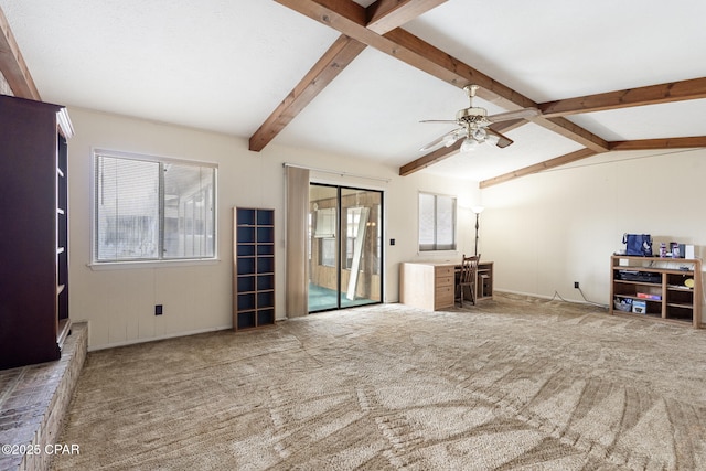 carpeted living room with vaulted ceiling with beams, ceiling fan, and plenty of natural light