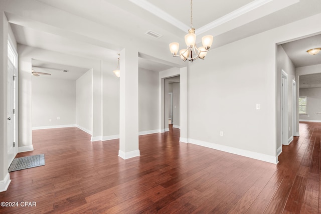 spare room featuring ceiling fan with notable chandelier and dark hardwood / wood-style flooring