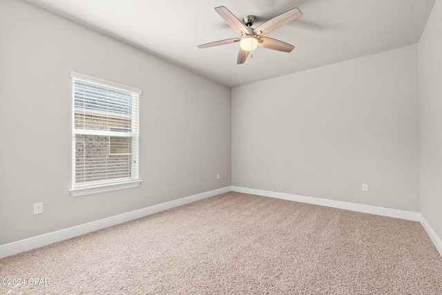 spare room featuring ceiling fan and carpet