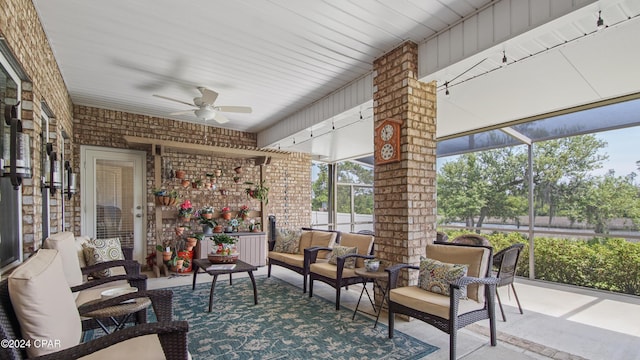 sunroom featuring ceiling fan