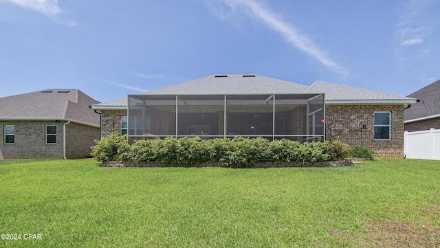 rear view of property with a yard