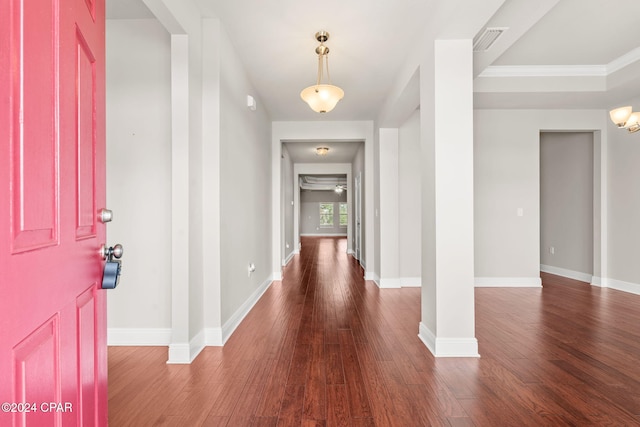 entrance foyer featuring ceiling fan, ornamental molding, and dark hardwood / wood-style flooring