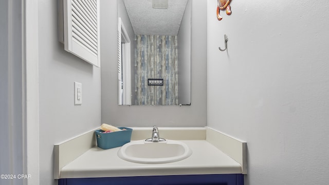 bathroom with a textured ceiling and vanity