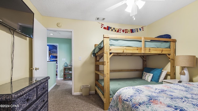 carpeted bedroom with a ceiling fan, baseboards, visible vents, and a textured ceiling