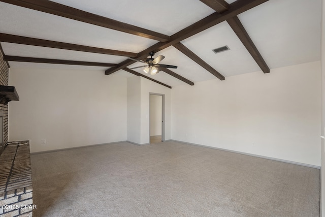 unfurnished living room featuring carpet, lofted ceiling with beams, ceiling fan, and a brick fireplace