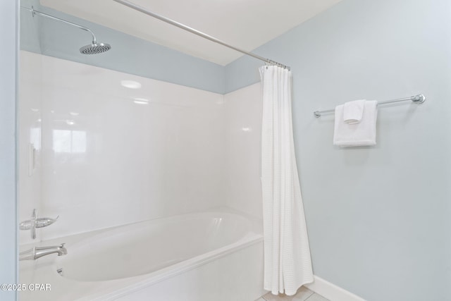 bathroom with tile patterned floors and shower / bath combo with shower curtain