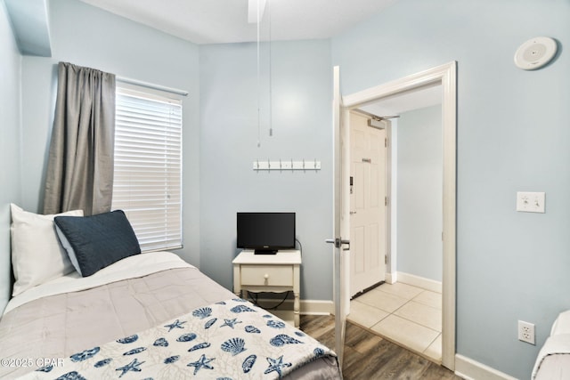 bedroom with ceiling fan and light hardwood / wood-style floors