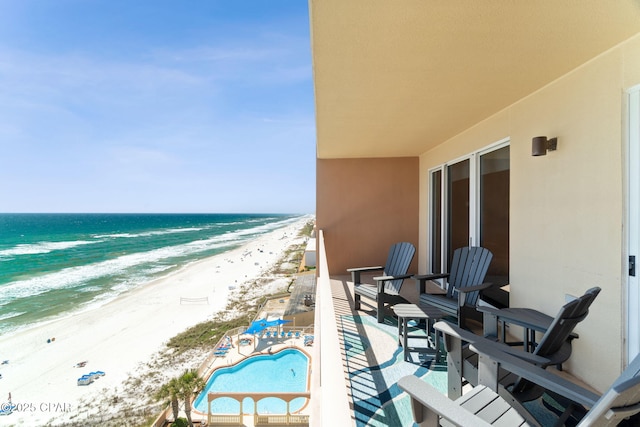 balcony featuring a water view and a view of the beach