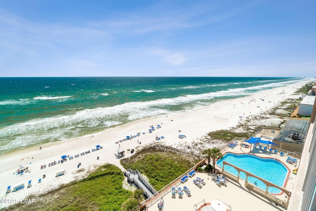 drone / aerial view with a beach view and a water view