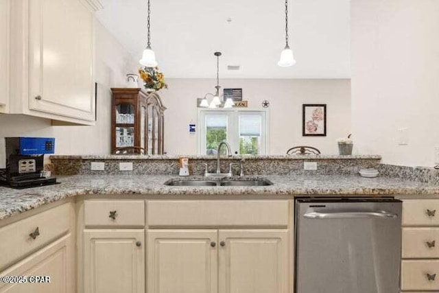 kitchen with a sink, a peninsula, an inviting chandelier, dishwasher, and hanging light fixtures