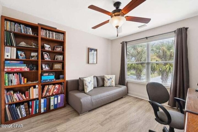 office with baseboards, a ceiling fan, and wood finished floors