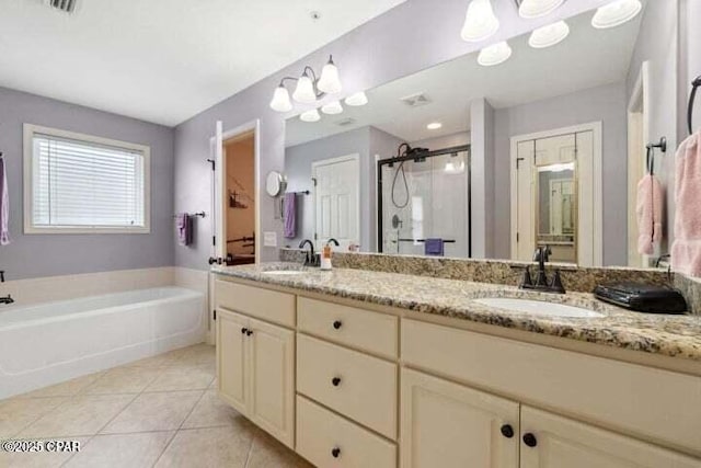 bathroom with a sink, a garden tub, a shower stall, and tile patterned flooring