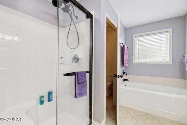 bathroom featuring toilet, a bath, a stall shower, and tile patterned flooring