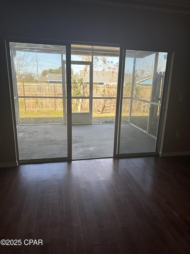 doorway with dark hardwood / wood-style floors